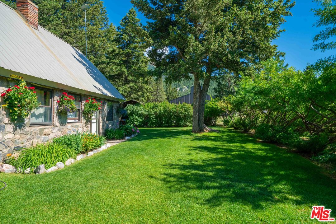 64050 Gallatin Road Gallatin Gateway, MT 59730 - Photo 44 of 55 a view of a house with a backyard