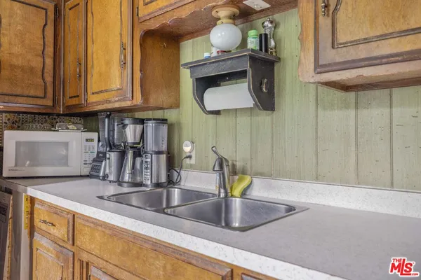 a kitchen with cabinets a sink and a counter top space