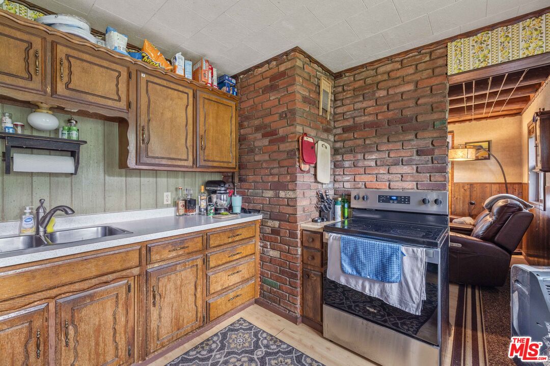 64050 Gallatin Road Gallatin Gateway, MT 59730 - Photo 7 of 55 a kitchen with stainless steel appliances granite countertop a stove and cabinets