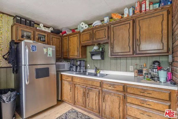 a kitchen with stainless steel appliances granite countertop a refrigerator sink and cabinets