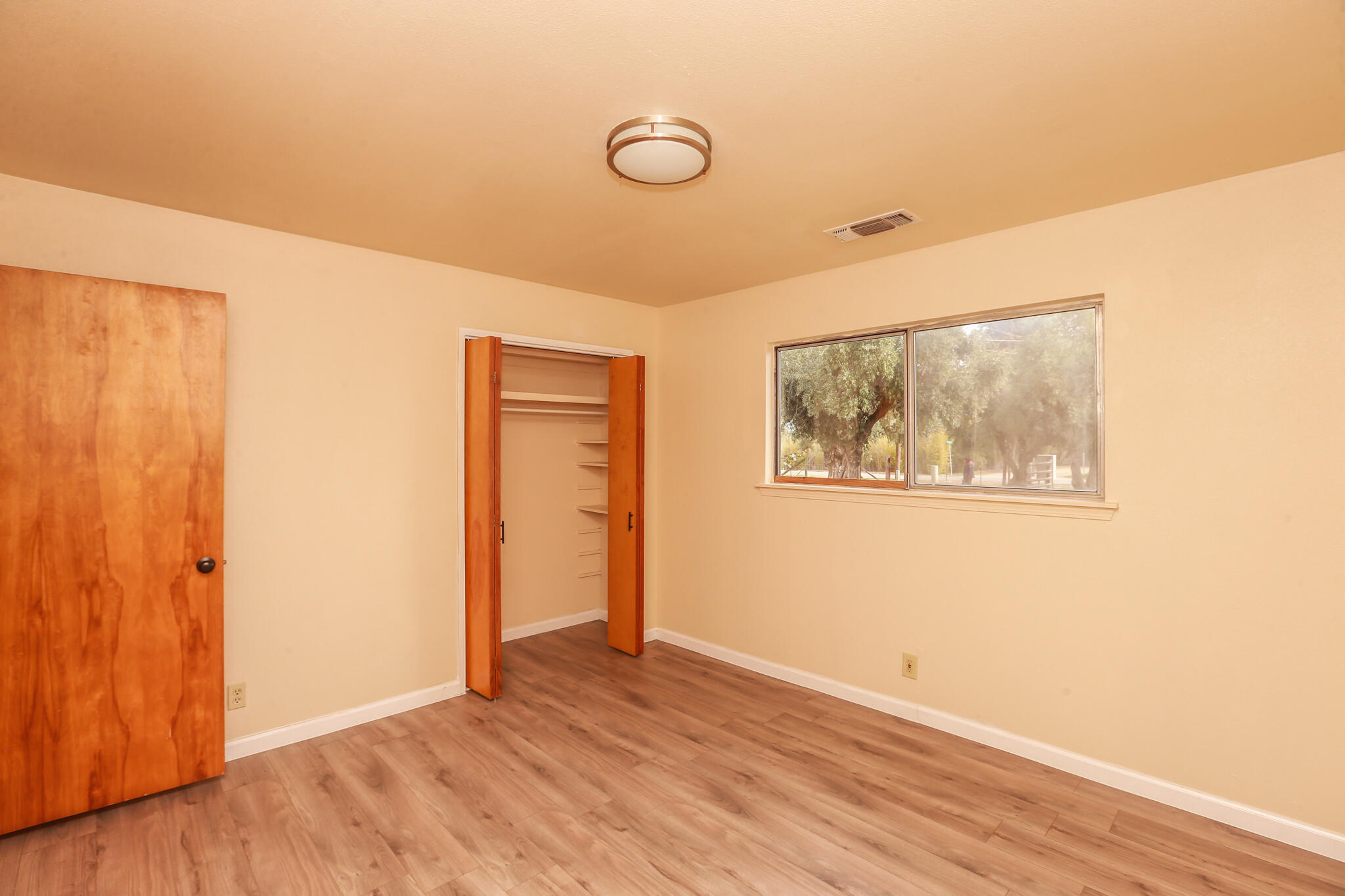 5572 Olive Street Anderson, CA 96007 - Photo 14 of 31 a view of an empty room with wooden floor and a window