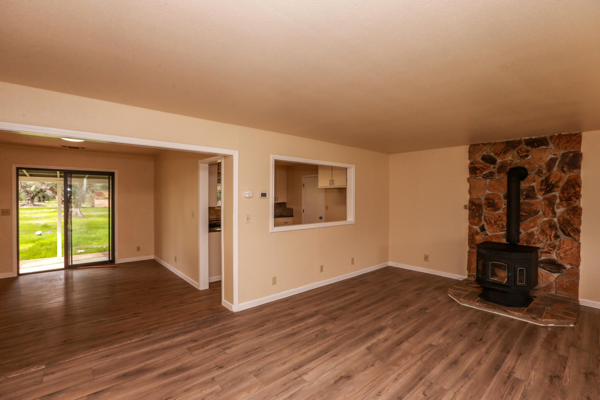 5572 Olive Street Anderson, CA 96007 - Photo 3 of 31 an empty room with wooden floor and windows