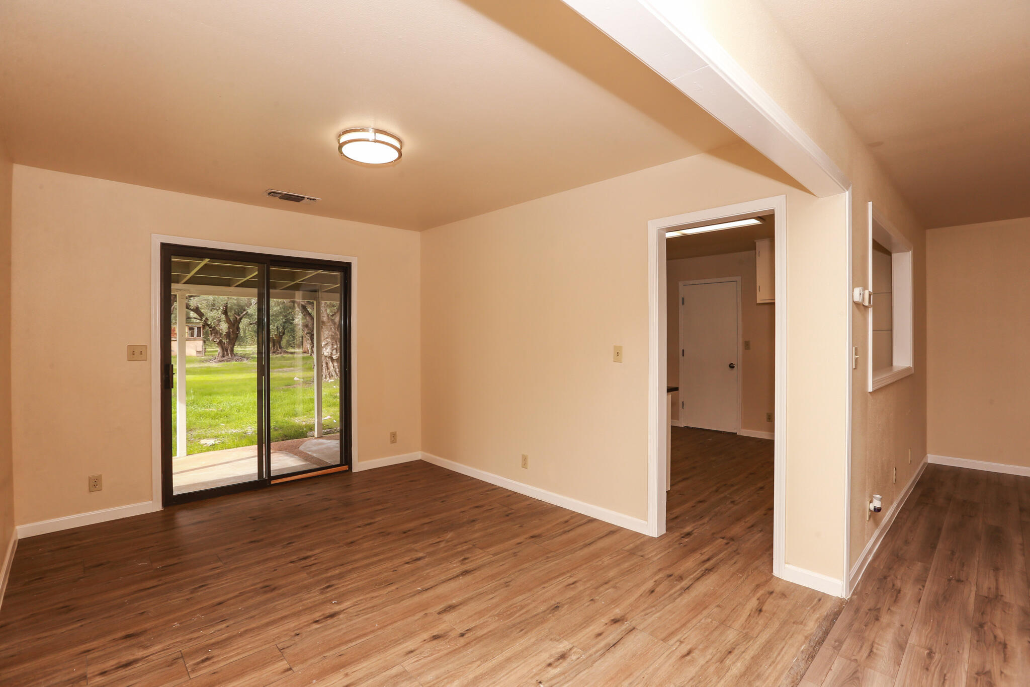 5572 Olive Street Anderson, CA 96007 - Photo 7 of 31 wooden floor in an empty room with a window