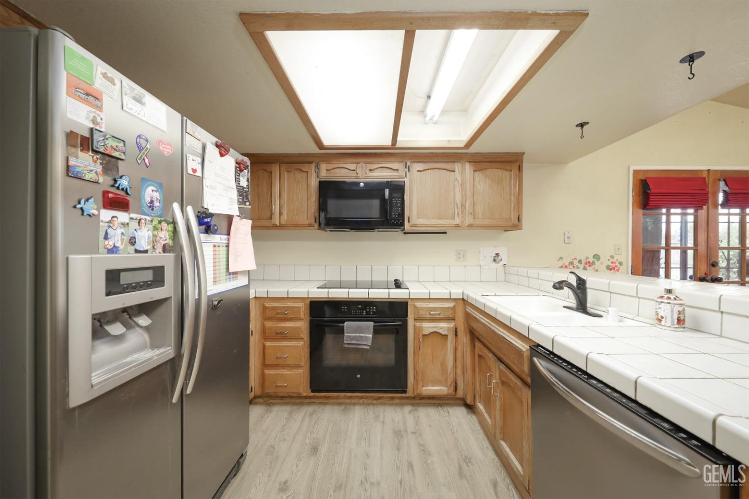 Undisclosed Address Bakersfield, CA 93314 - Photo 12 of 29 a kitchen with stainless steel appliances granite countertop a sink and a stove top oven