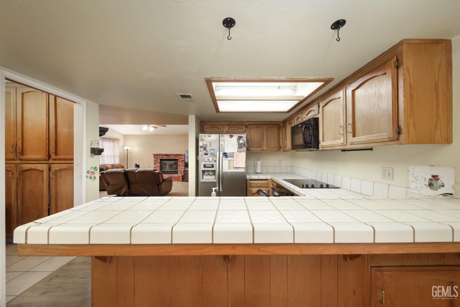 Undisclosed Address Bakersfield, CA 93314 - Photo 13 of 29 a large white bed sitting in a kitchen next to a window