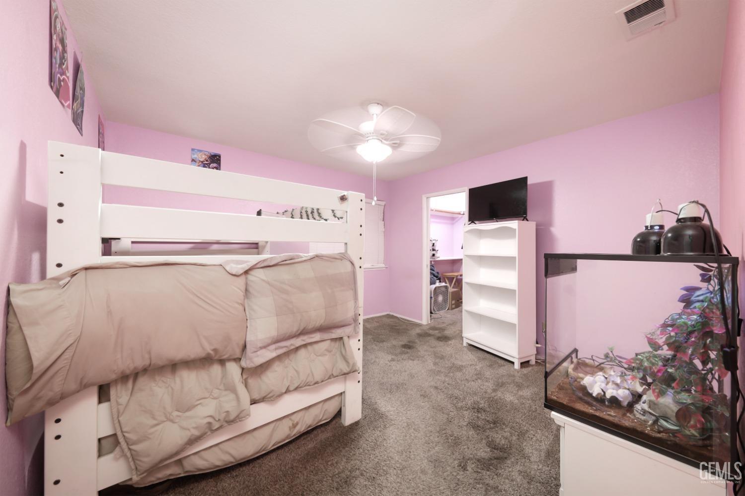 Undisclosed Address Bakersfield, CA 93314 - Photo 19 of 29 a bedroom with a bed and a flat screen tv