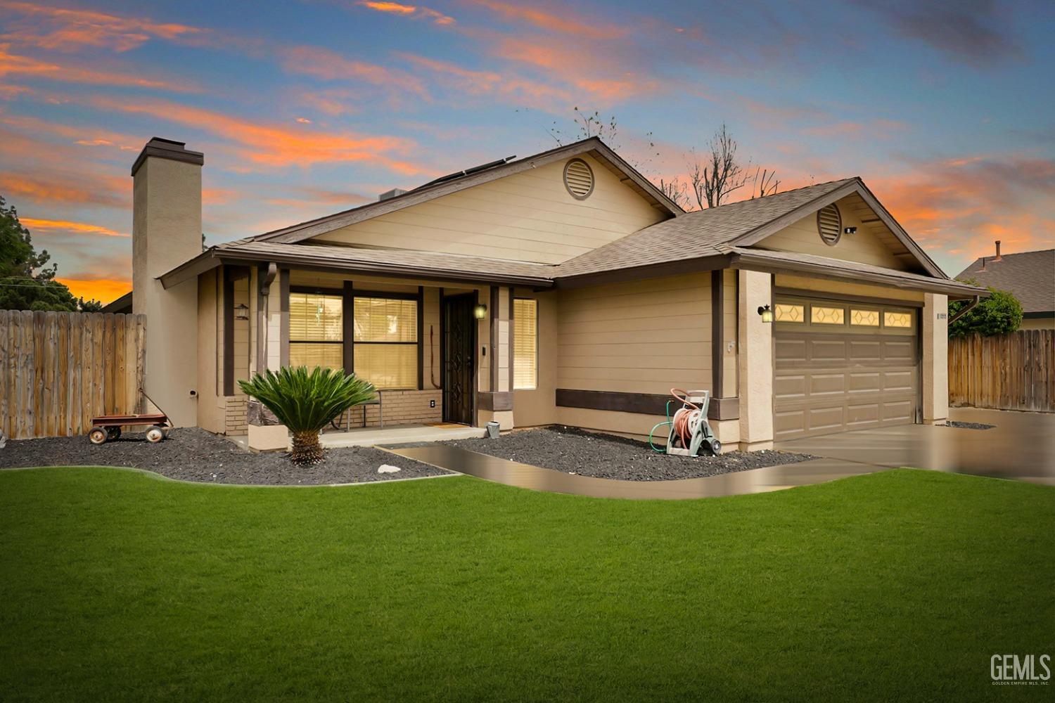 Undisclosed Address Bakersfield, CA 93314 - Photo 2 of 29 a front view of a house with a yard and garage