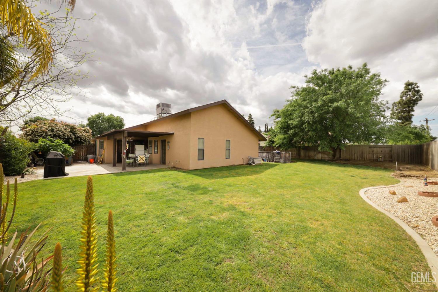 Undisclosed Address Bakersfield, CA 93314 - Photo 25 of 29 a view of a backyard with table and chairs and potted plants