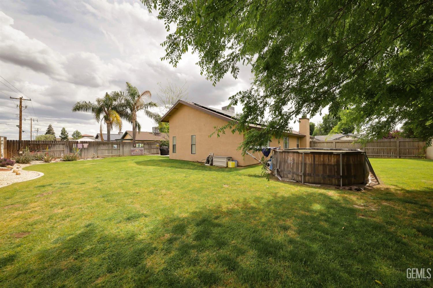 Undisclosed Address Bakersfield, CA 93314 - Photo 26 of 29 a view of backyard with swimming pool and seating area
