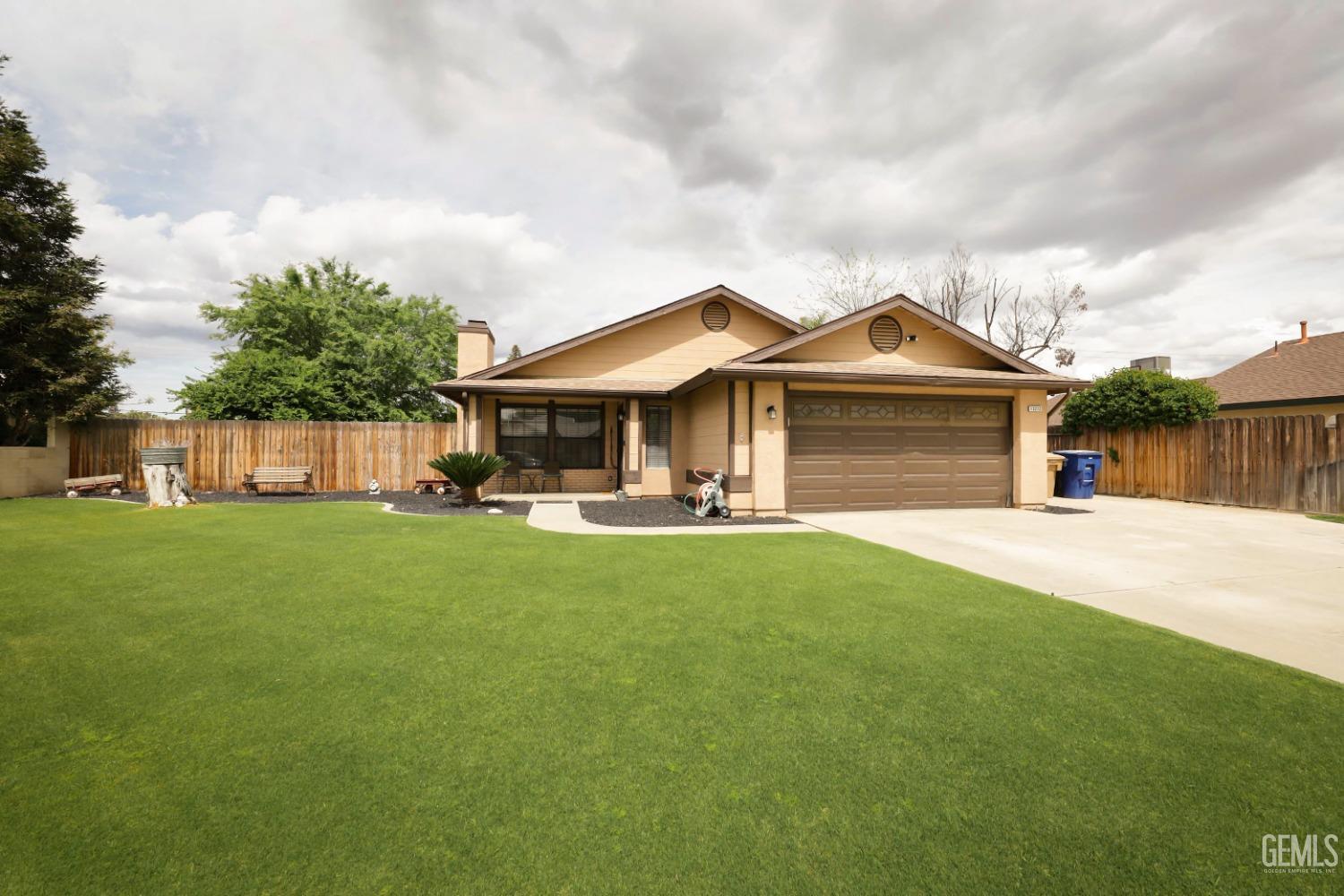 Undisclosed Address Bakersfield, CA 93314 - Photo 3 of 29 a front view of a house with garden