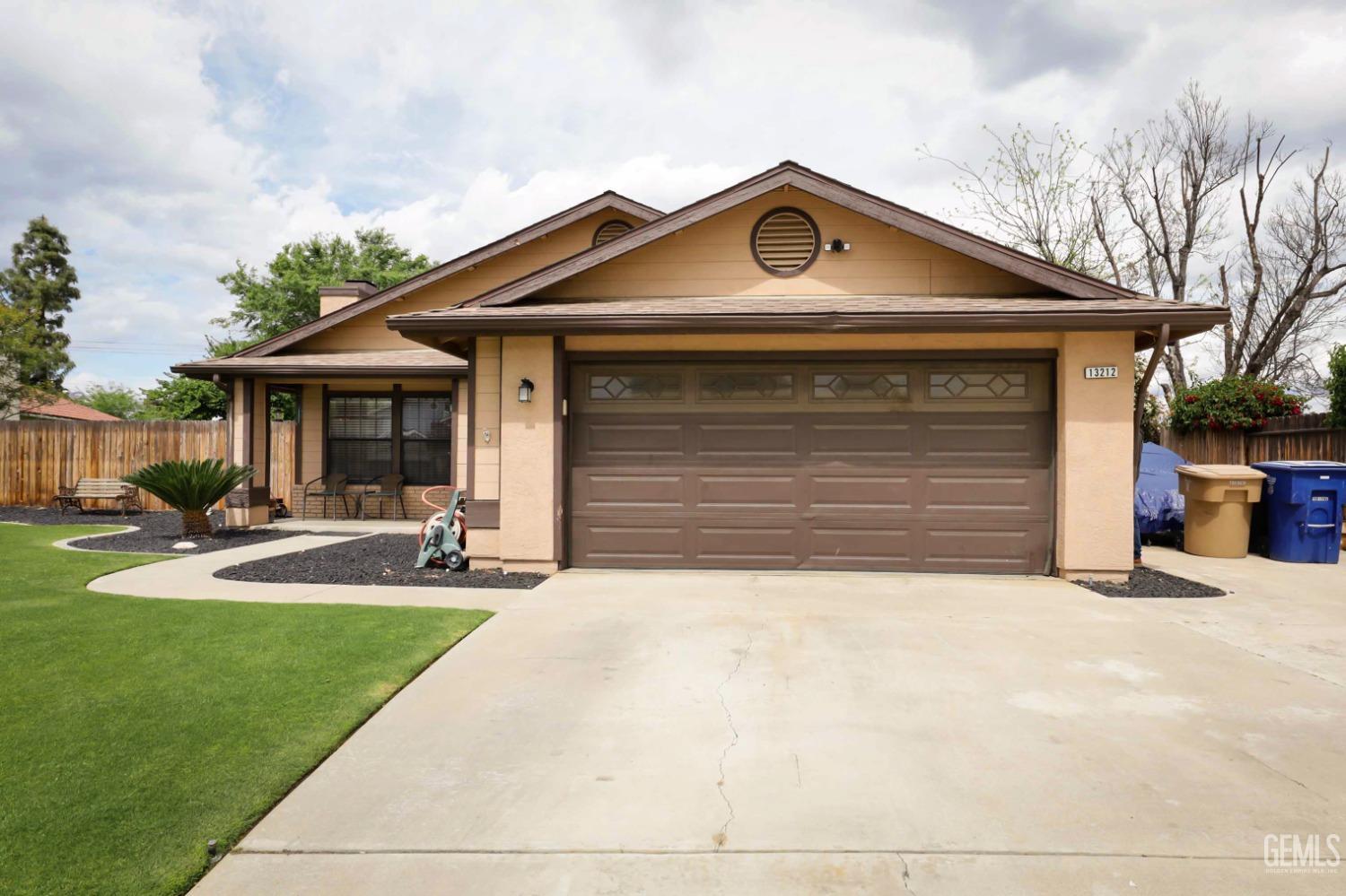 Undisclosed Address Bakersfield, CA 93314 - Photo 4 of 29 a front view of a house with garden