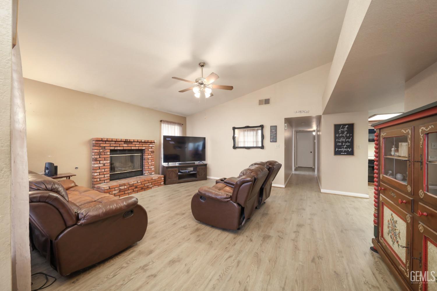 Undisclosed Address Bakersfield, CA 93314 - Photo 9 of 29 a living room with furniture a fireplace and a flat screen tv