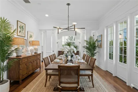 a dining room with furniture window and wooden floor