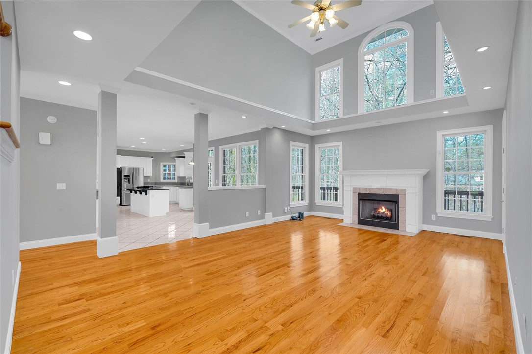 204 Red Maple Way Clemson, SC 29631 - Photo 5 of 48 This living room features gleaming hardwood floors and an inviting fireplace, perfect for gatherings.