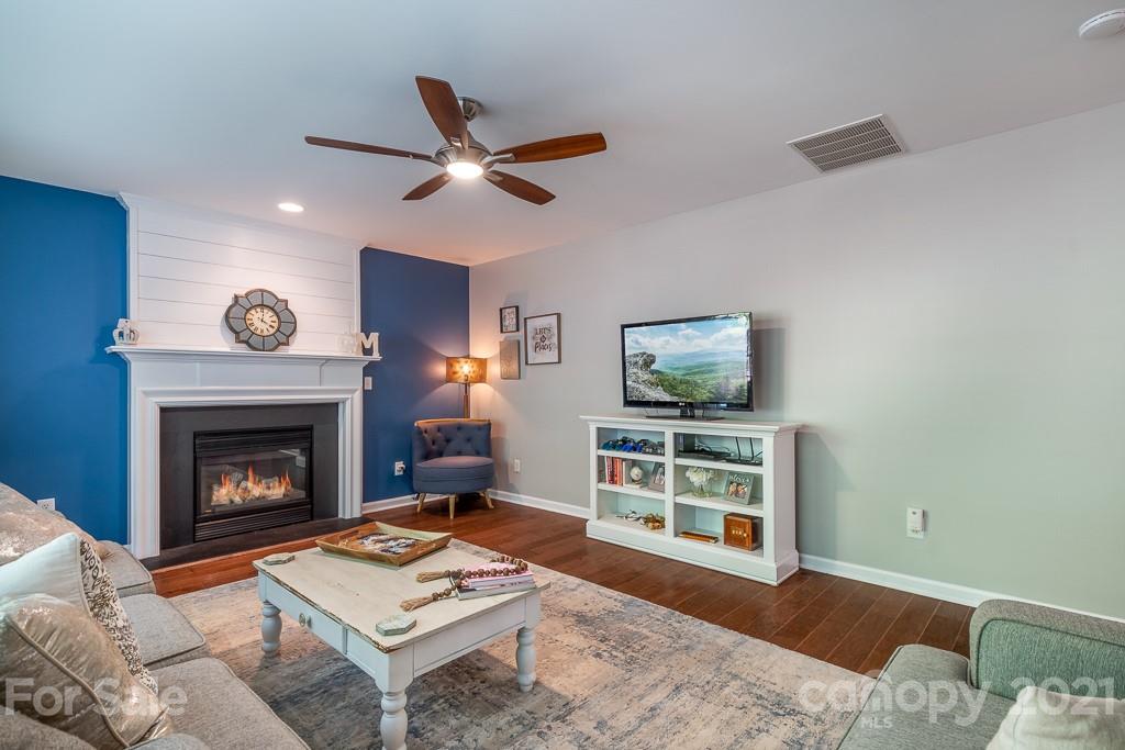 18122 Bluff Inlet Road Cornelius, NC 28031 - Photo 17 of 34 a living room with furniture and a fireplace