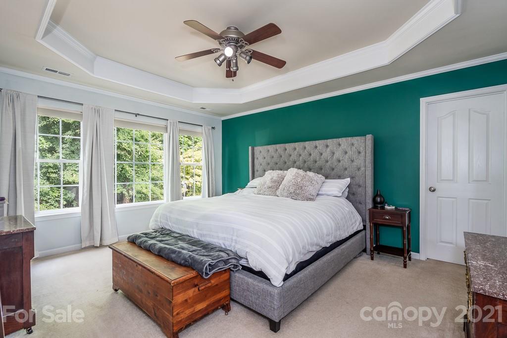 18122 Bluff Inlet Road Cornelius, NC 28031 - Photo 20 of 34 a bed sitting in a bedroom next to a window