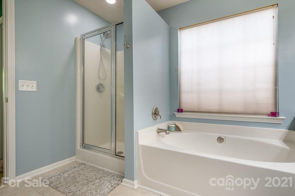 18122 Bluff Inlet Road Cornelius, NC 28031 - Photo 23 of 34 a bathroom with a bathtub and shower