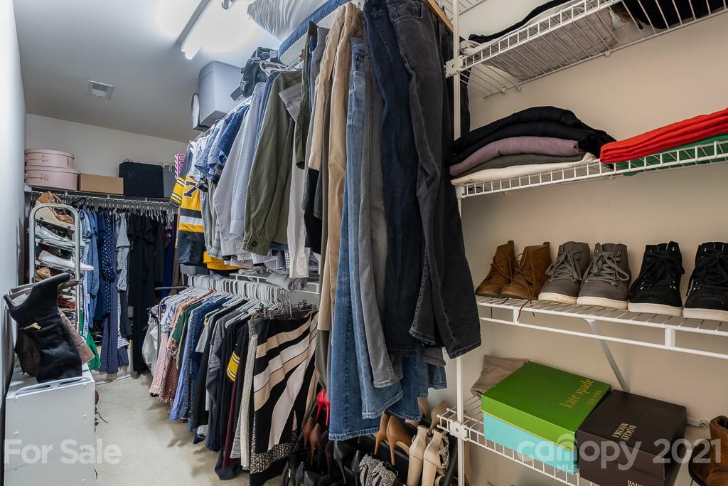 18122 Bluff Inlet Road Cornelius, NC 28031 - Photo 24 of 34 a view of walk in closet with clothes and shoes