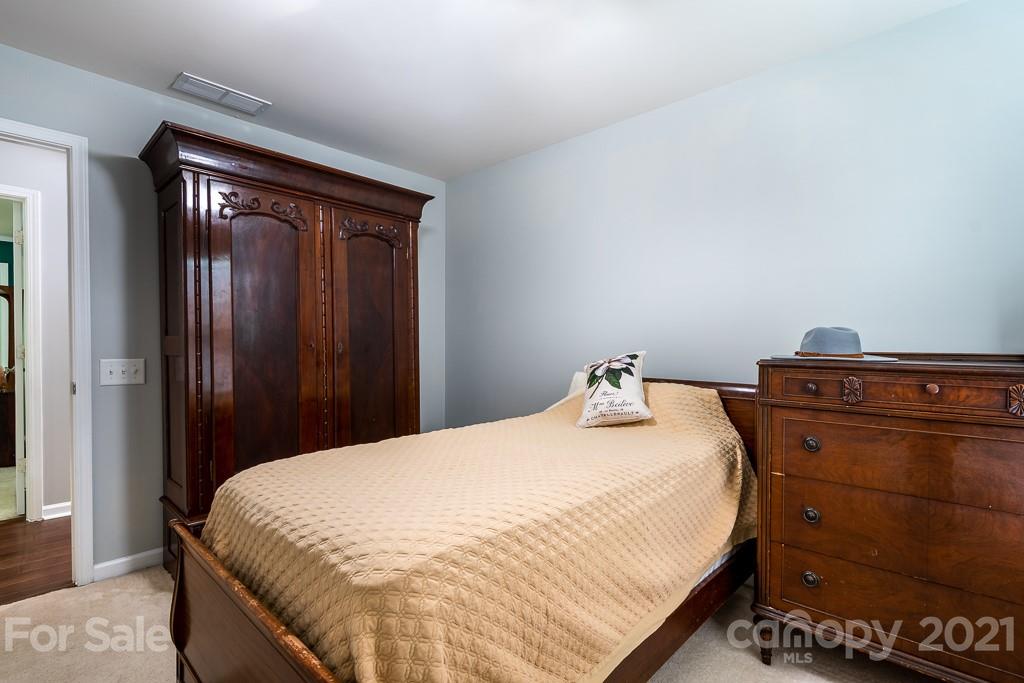18122 Bluff Inlet Road Cornelius, NC 28031 - Photo 26 of 34 a bedroom with a bed and a mirror