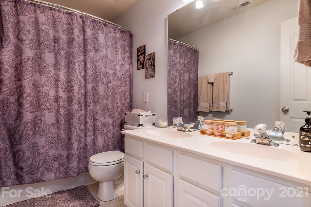 18122 Bluff Inlet Road Cornelius, NC 28031 - Photo 28 of 34 a bathroom with a granite countertop sink mirror vanity and toilet