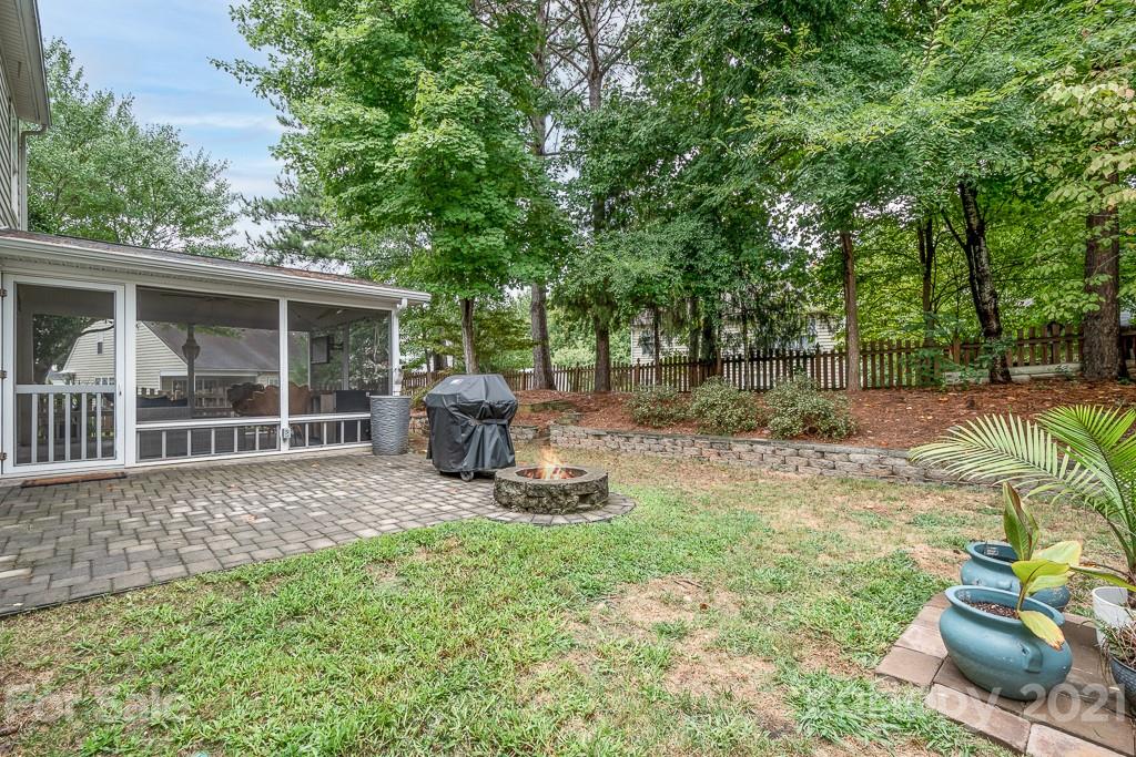 18122 Bluff Inlet Road Cornelius, NC 28031 - Photo 29 of 34 a view of a backyard with table and chairs potted plants and large tree