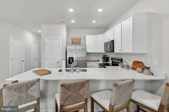 a kitchen with a sink and wooden floor