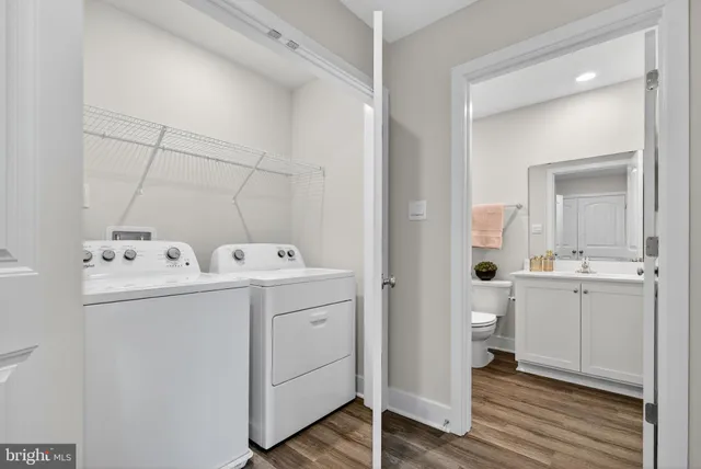 a view of a hallway with wooden floor and closet