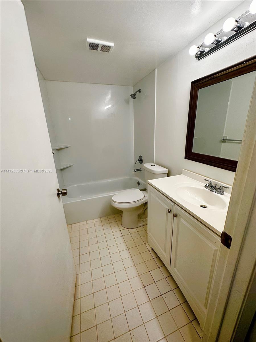 530 South Park Road, Unit 1711 Hollywood, FL 33021 - Photo 17 of 25 a bathroom with a sink a toilet and mirror