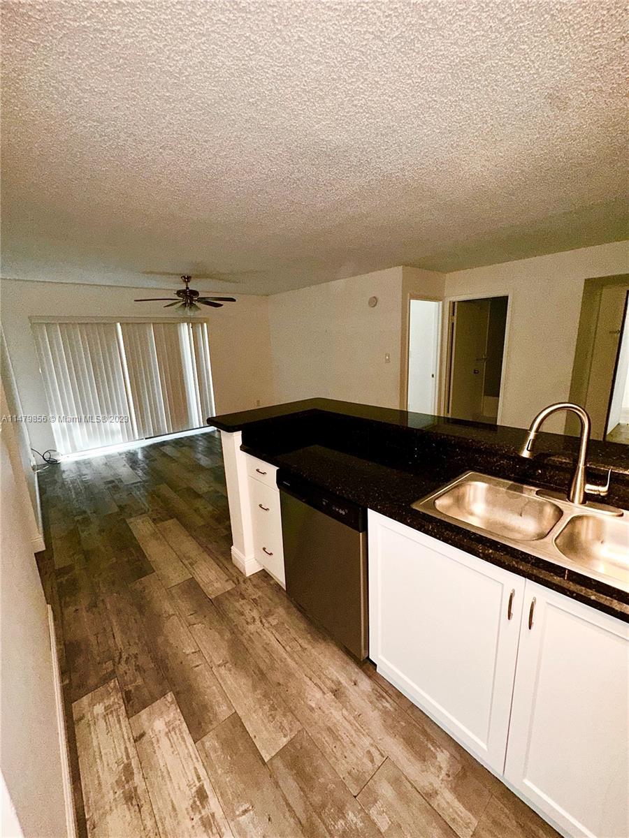 530 South Park Road, Unit 1711 Hollywood, FL 33021 - Photo 4 of 25 a kitchen with a sink and cabinets