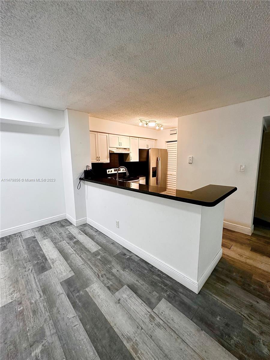 530 South Park Road, Unit 1711 Hollywood, FL 33021 - Photo 5 of 25 a kitchen with stainless steel appliances a sink and a microwave