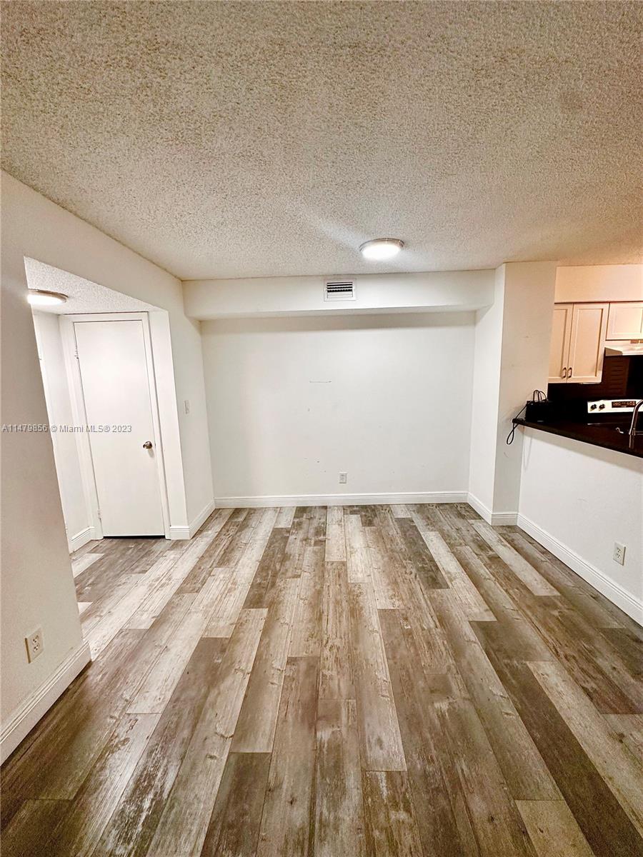 530 South Park Road, Unit 1711 Hollywood, FL 33021 - Photo 7 of 25 a view of a room with wooden floor and cabinets