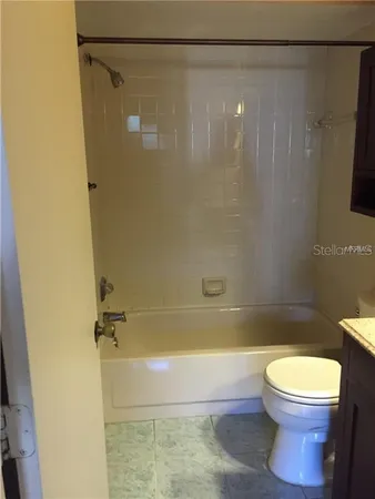 a bathroom with a shower and a toilet