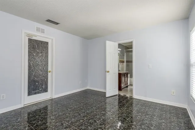 an empty room with windows and closet