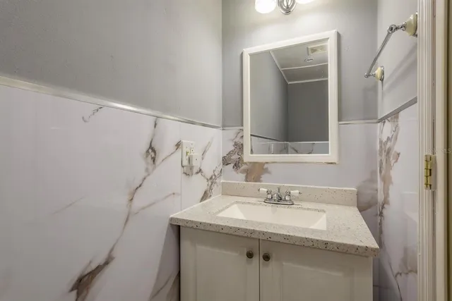 a bathroom with a sink and mirror