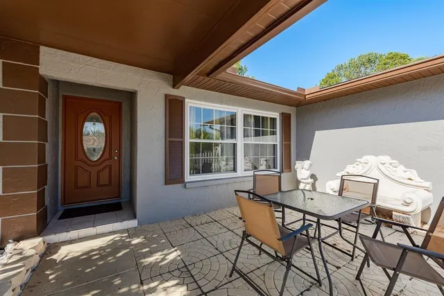 a view of a house with backyard and sitting area