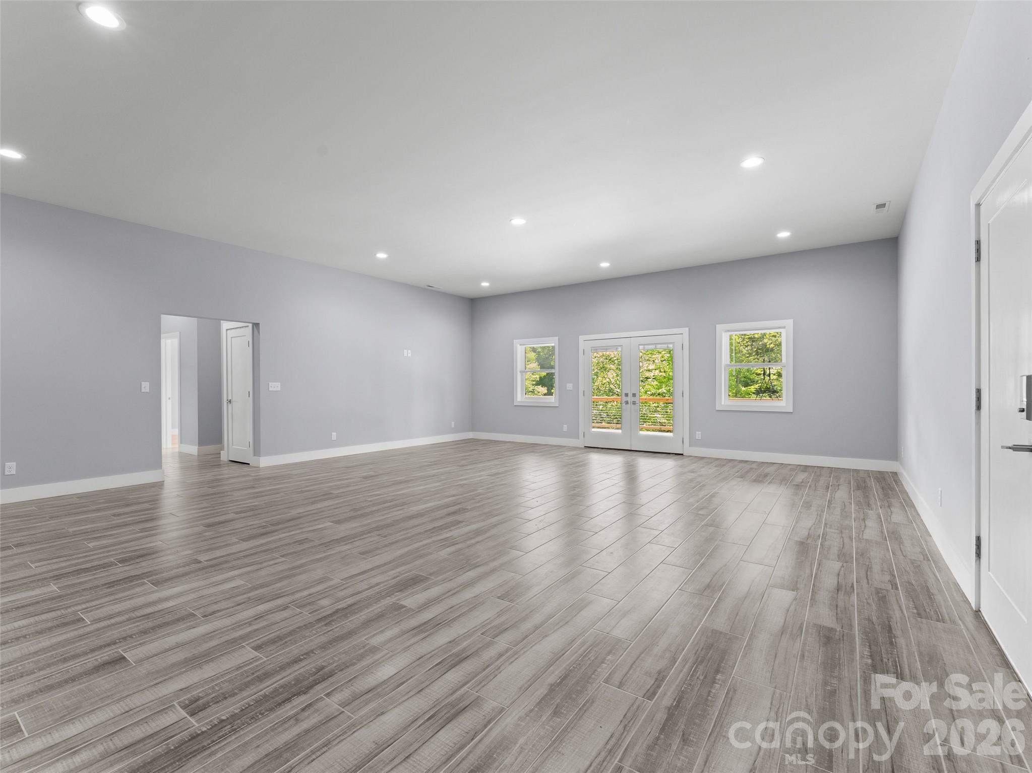 123 Israel Road Candler, NC 28715 - Photo 33 of 44 a view of an empty room with window and wooden floor