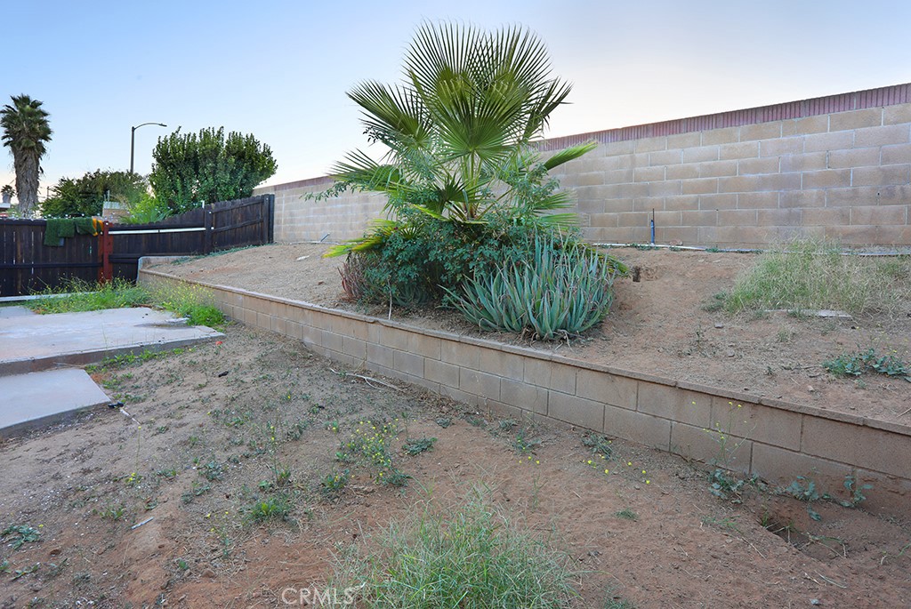 27603 Genevieve Drive Menifee, CA 92586 - Photo 10 of 11 a view of a yard with plants and wooden fence