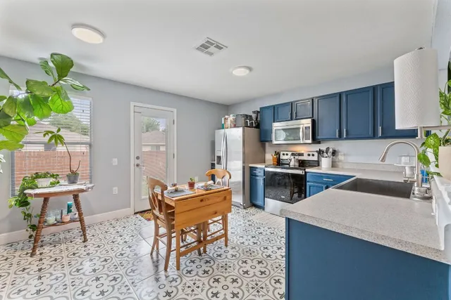 a living room with a couch and a potted plant