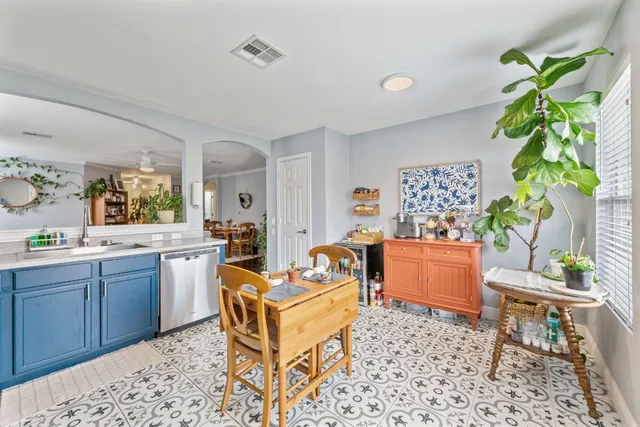 a kitchen with stainless steel appliances granite countertop a refrigerator a stove top oven and a sink