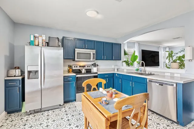 a kitchen with a sink and a large window