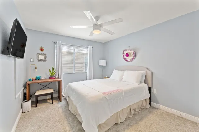 a bedroom with a bed and a flat screen tv