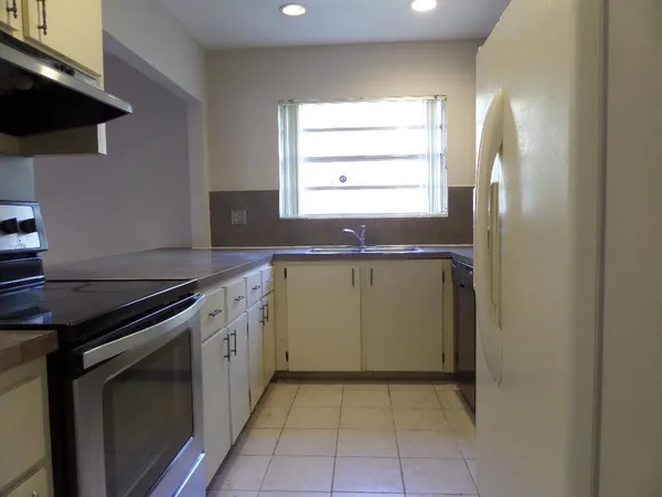 a kitchen with a sink stove and cabinets