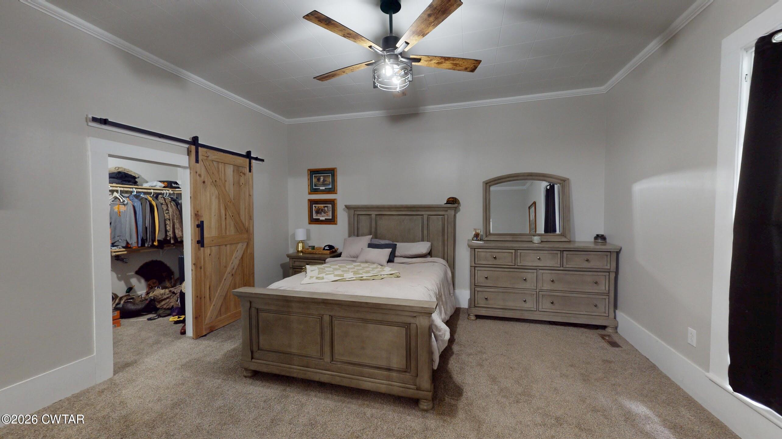 2800 Locust Grove Road Newbern, TN 38059 - Photo 27 of 46 a bedroom with a bed and a chandelier