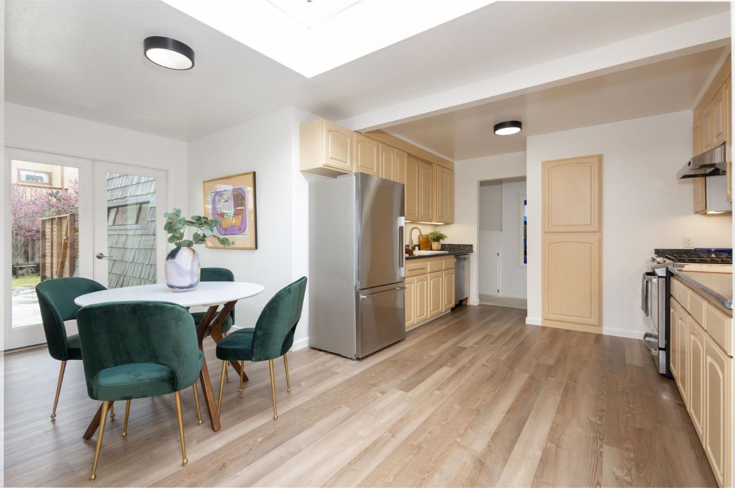 314 Roosevelt Boulevard Half Moon Bay, CA 94019 - Photo 19 of 58 a kitchen with refrigerator cabinets dining table and chairs