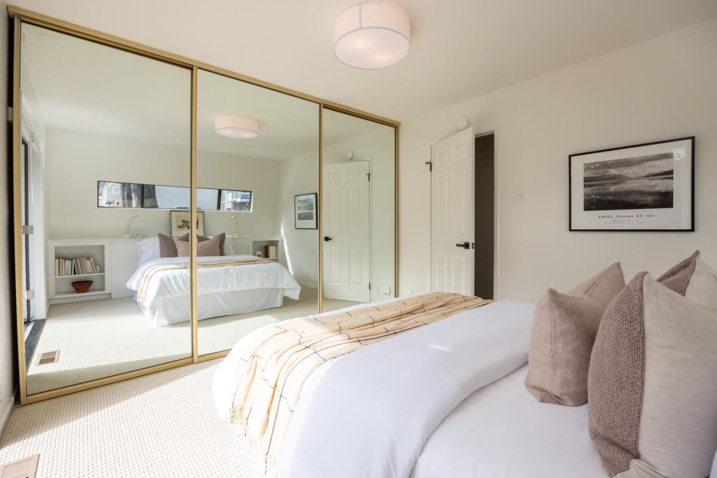 314 Roosevelt Boulevard Half Moon Bay, CA 94019 - Photo 28 of 58 a bedroom with a large bed and a large mirror