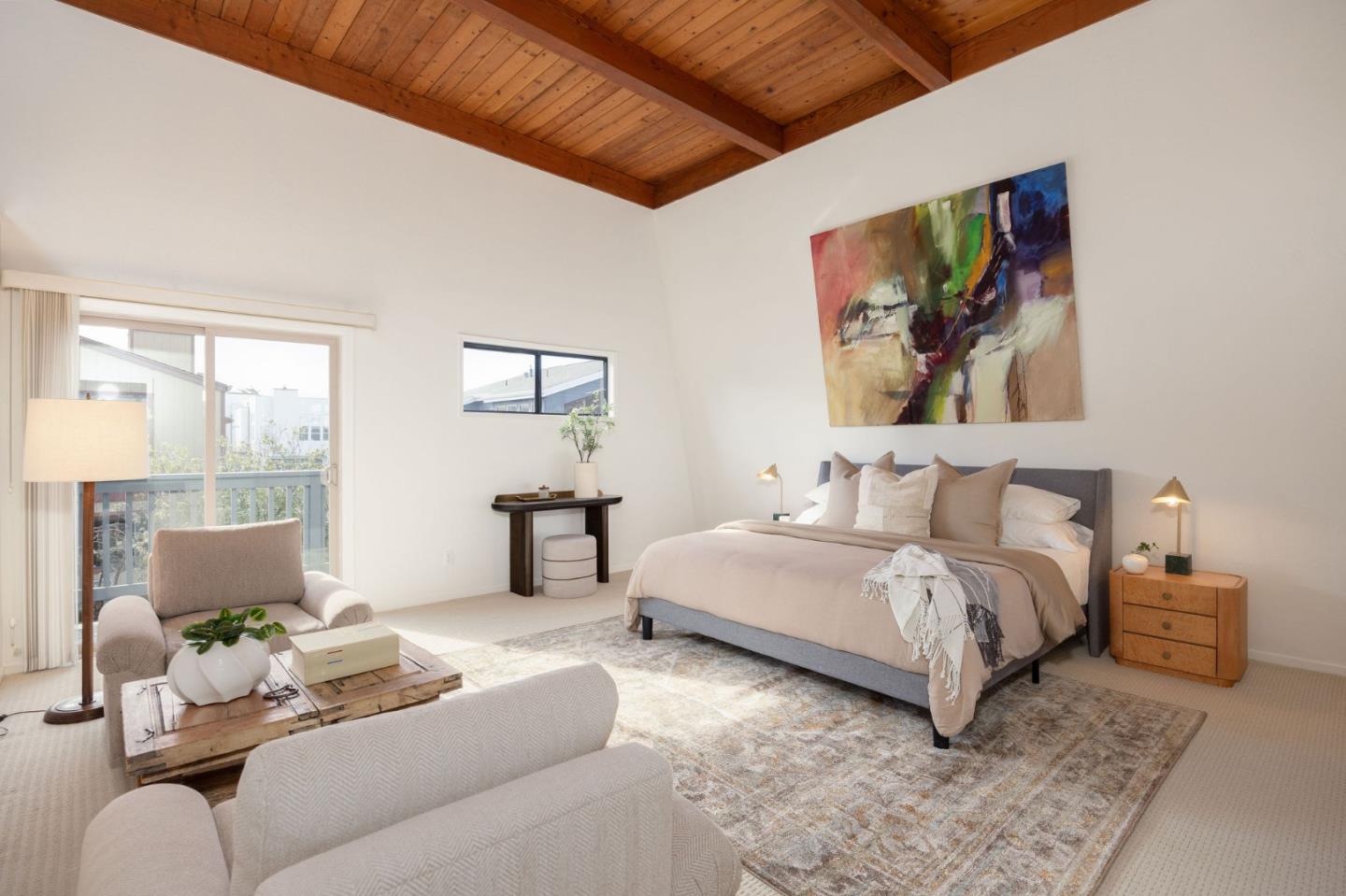 314 Roosevelt Boulevard Half Moon Bay, CA 94019 - Photo 36 of 58 a spacious bedroom with a bed a couch and large window