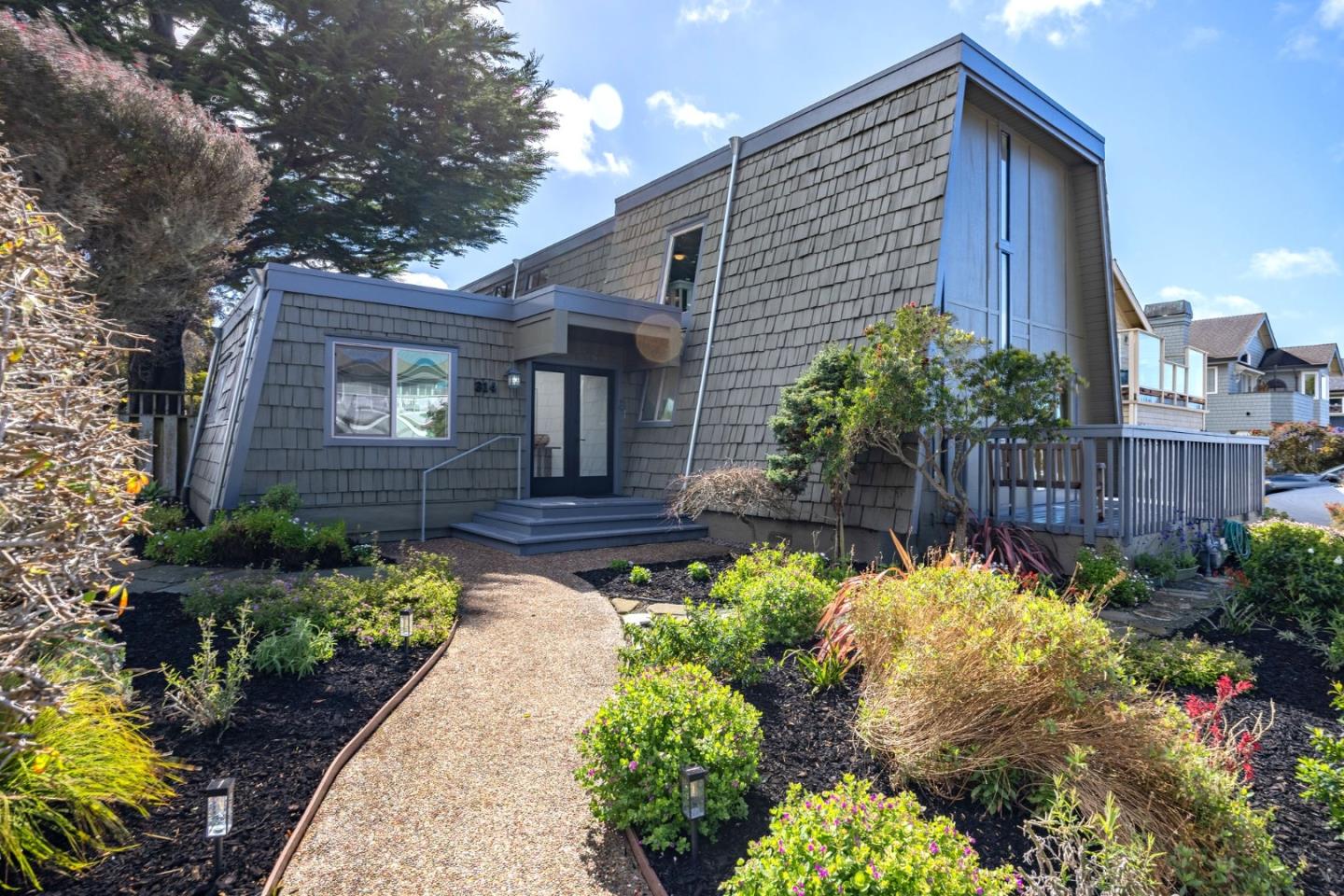 314 Roosevelt Boulevard Half Moon Bay, CA 94019 - Photo 6 of 58 a front view of a house with a yard