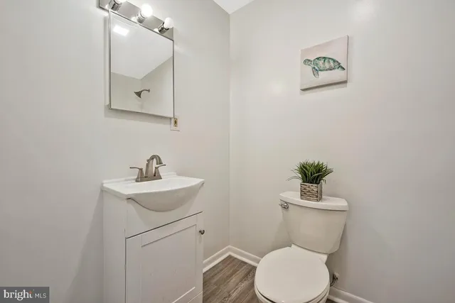 a bathroom with a toilet a sink and mirror