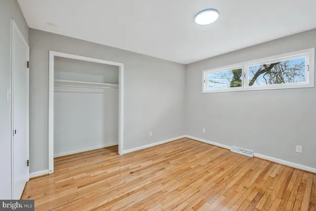 wooden floor in an empty room with a workspace