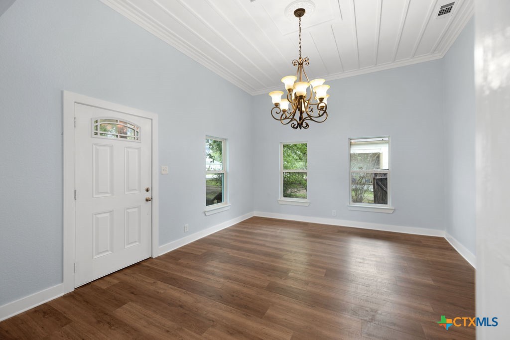 607 West 3rd Street Eddy, TX 76524 - Photo 6 of 29 a view of livingroom with chandelier and wooden floor